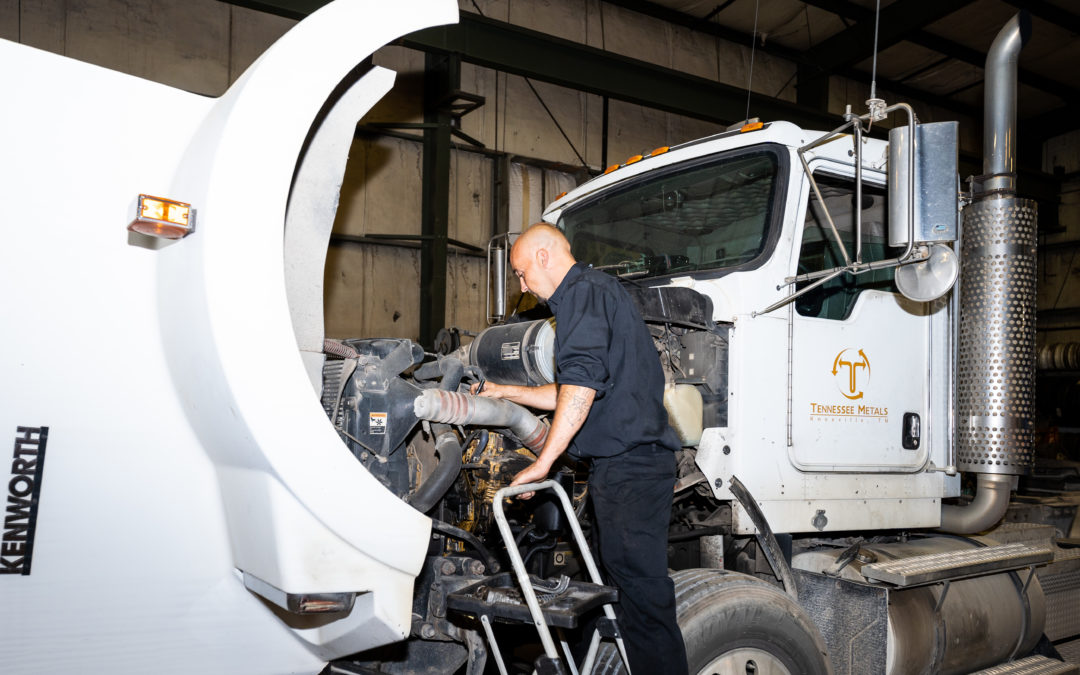 Diesel technician exploring the engine of a diesel truck